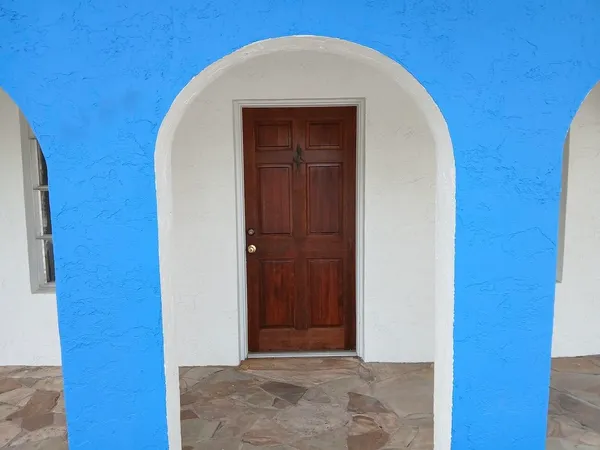 a view of a dining room with furniture large windows and wooden floor