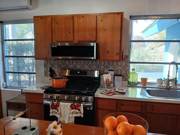 a bedroom with a bed and a lamp on the dresser