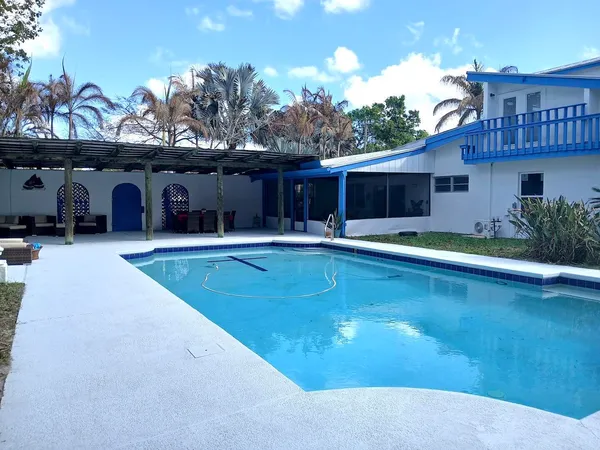a living room with furniture dining table a lamp and a window