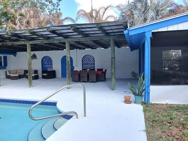 a kitchen with a table chairs and a refrigerator