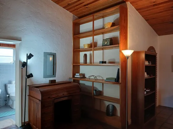 a bedroom with a bed and a large window