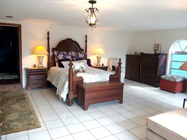 a view of a bedroom with furniture and tv