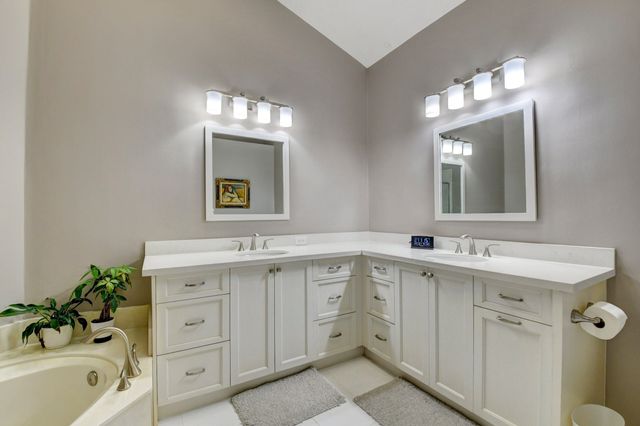 a bathroom with a sink double vanity and a mirror