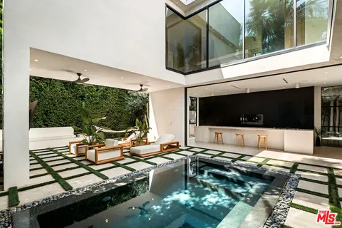 a living room filled with furniture and a flat screen tv