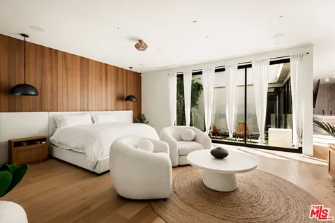 a bed room with a bed and a large window