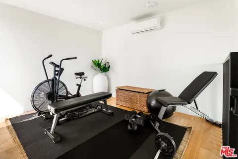 a room with gym equipment on wooden floor