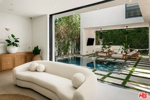 a living room with furniture tv and a large window