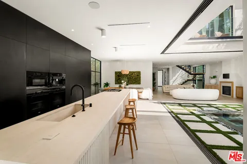 a large kitchen with a table and chairs