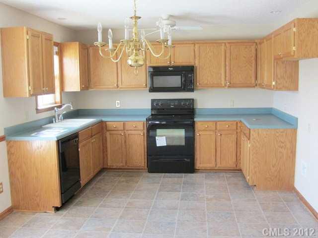 476 Owens Road York, SC 29745 - Photo 12 of 12 a kitchen with a stove sink and cabinets