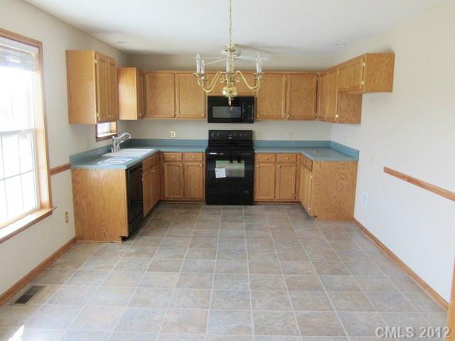476 Owens Road York, SC 29745 - Photo 4 of 12 a kitchen with a stove a sink and a refrigerator