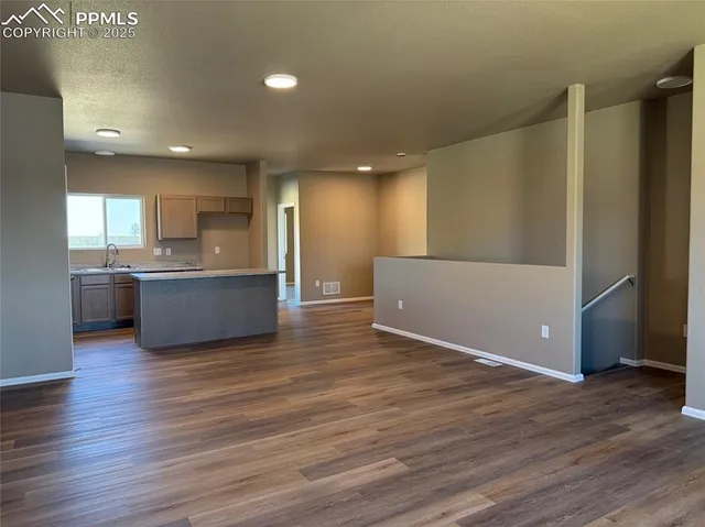 a view of a kitchen with a sink and a refrigerator