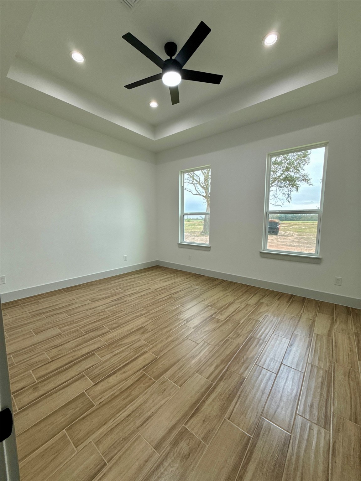 931 Buffalo Trail Angleton, TX 77515 - Photo 12 of 20 an empty room with wooden floor and windows