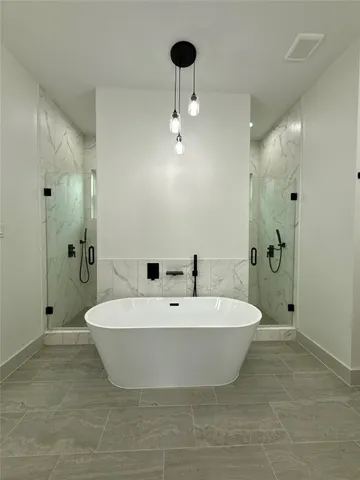a spacious bathroom with a bathtub and shower