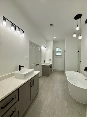a bathroom with a tub sink and mirror