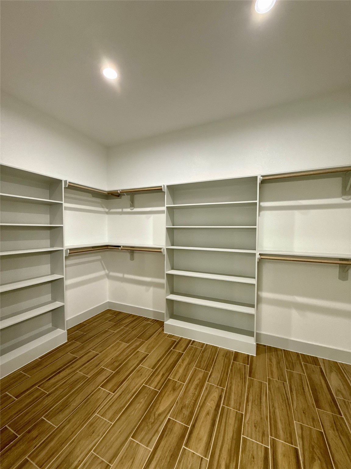 931 Buffalo Trail Angleton, TX 77515 - Photo 16 of 20 a view of walk in closet with empty racks