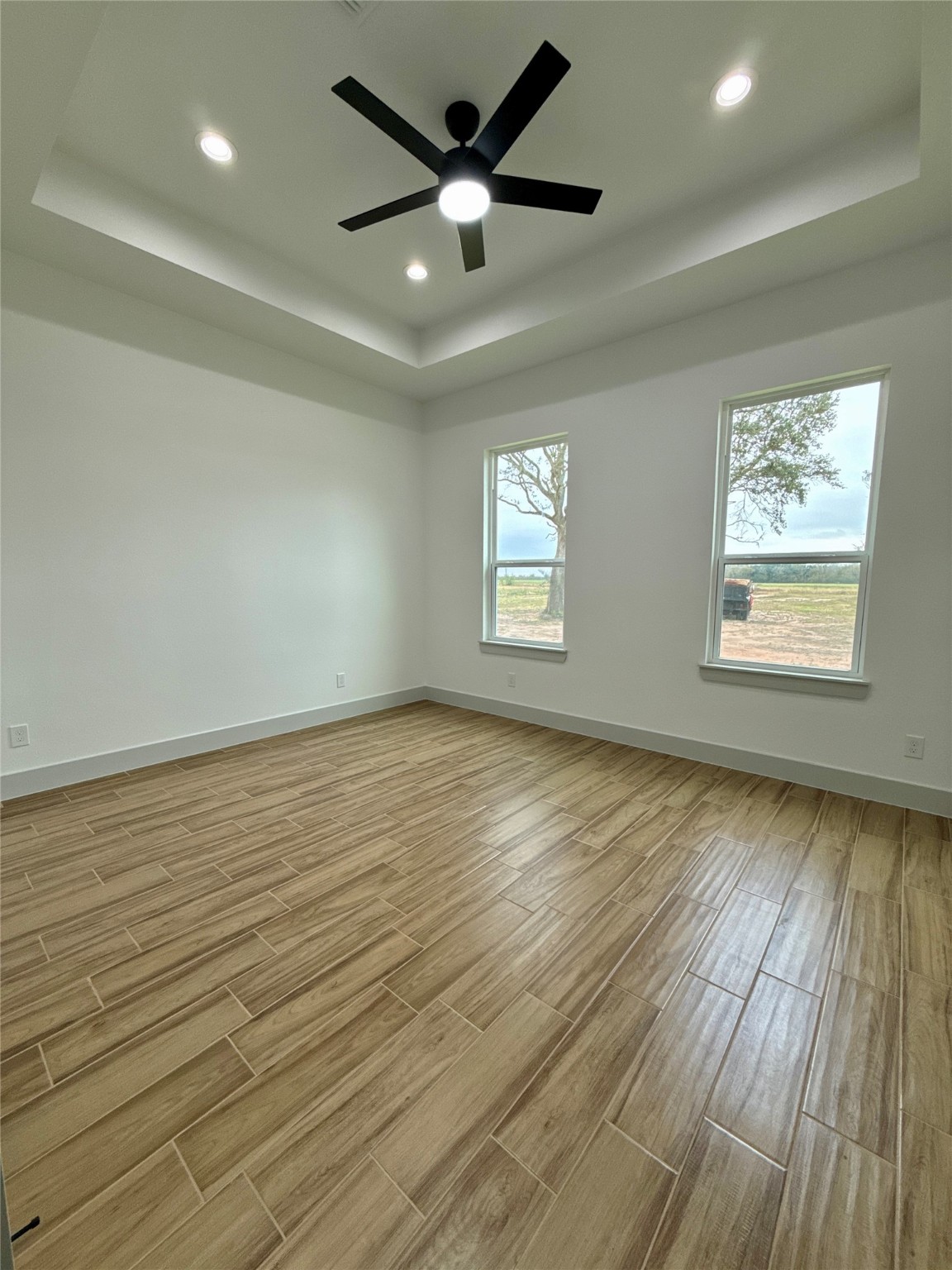 931 Buffalo Trail Angleton, TX 77515 - Photo 18 of 20 an empty room with wooden floor and windows