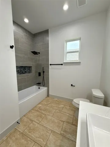 a bathroom with a bathtub and toilet