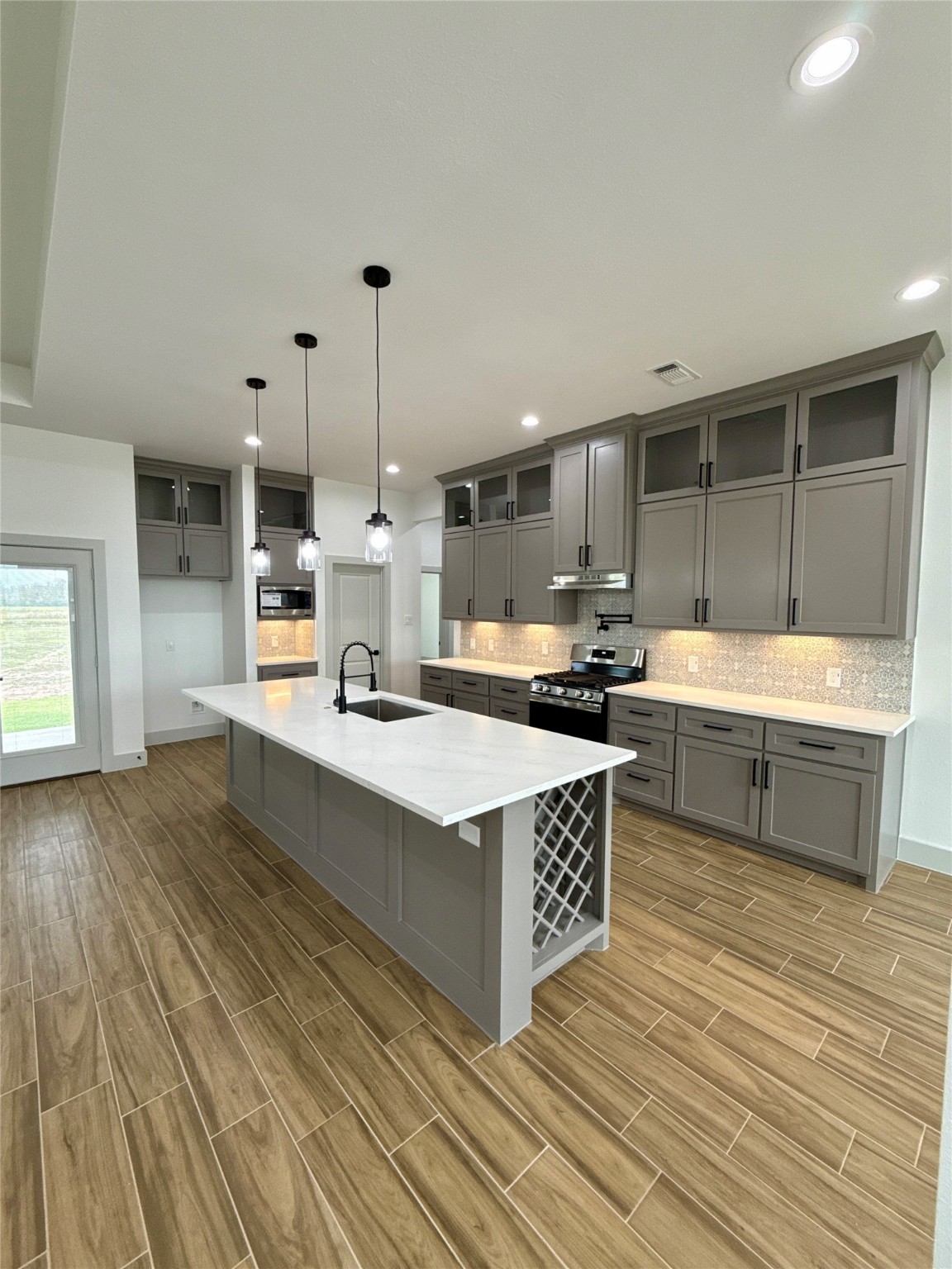931 Buffalo Trail Angleton, TX 77515 - Photo 5 of 20 a kitchen with stainless steel appliances kitchen island granite countertop a sink and a stove