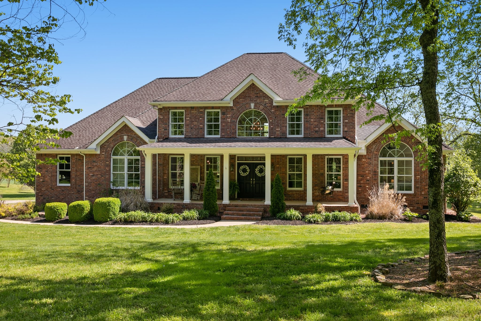 a front view of a house with a garden