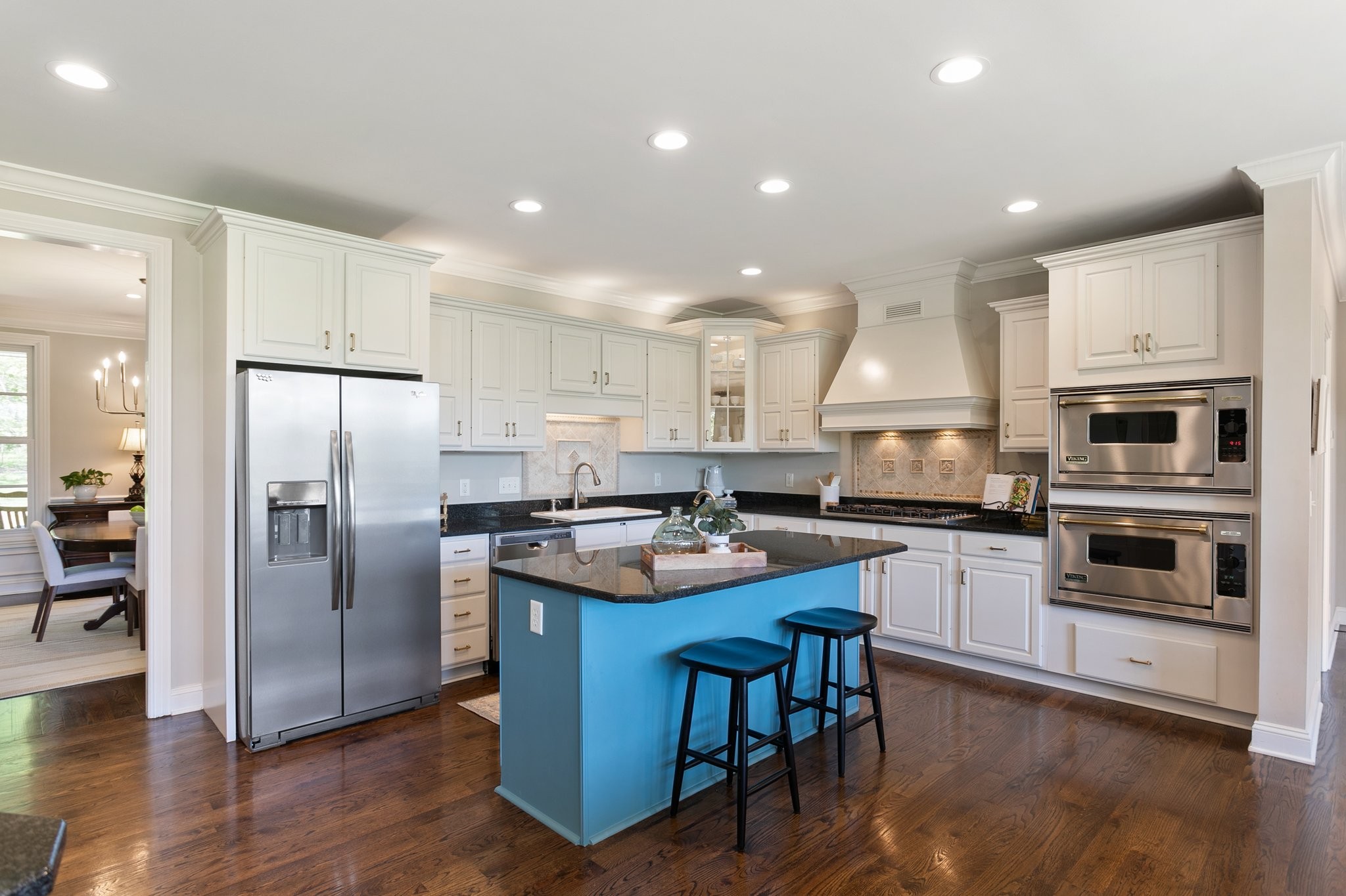 4360 Arno Road Franklin, TN 37064 - Photo 7 of 24 a kitchen with stainless steel appliances granite countertop a refrigerator a stove a sink a dining table and chairs