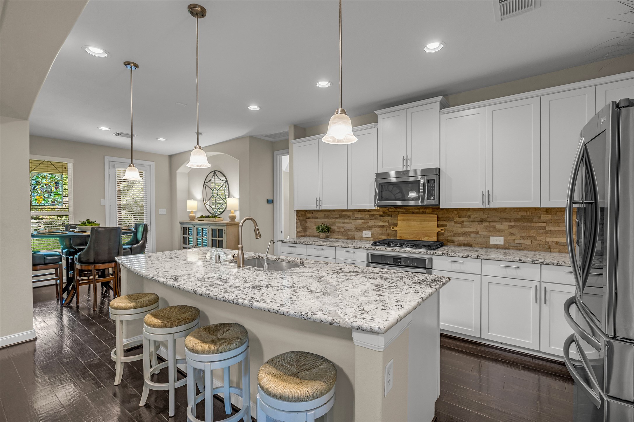 22419 Sawmill Ranch Drive Spring, TX 77389 - Photo 12 of 45 The large island provides a convenient place to have a quick bite or enjoy conversation with the chef.