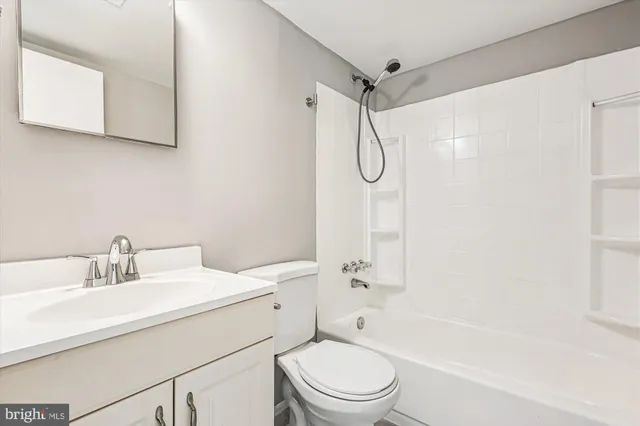 a bathroom with a sink toilet vanity and shower