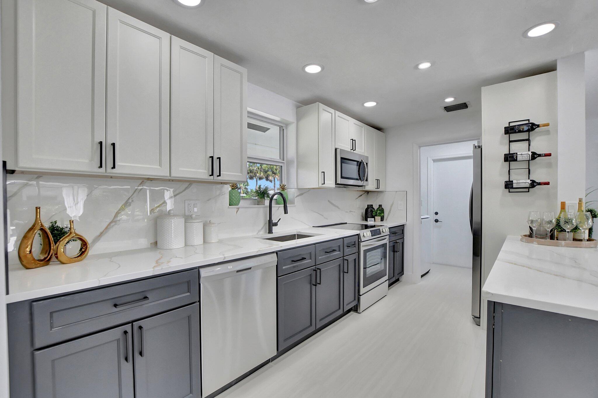 832 Southwest 10th Avenue Boca Raton, FL 33486 - Photo 6 of 57 a kitchen with a sink and cabinets