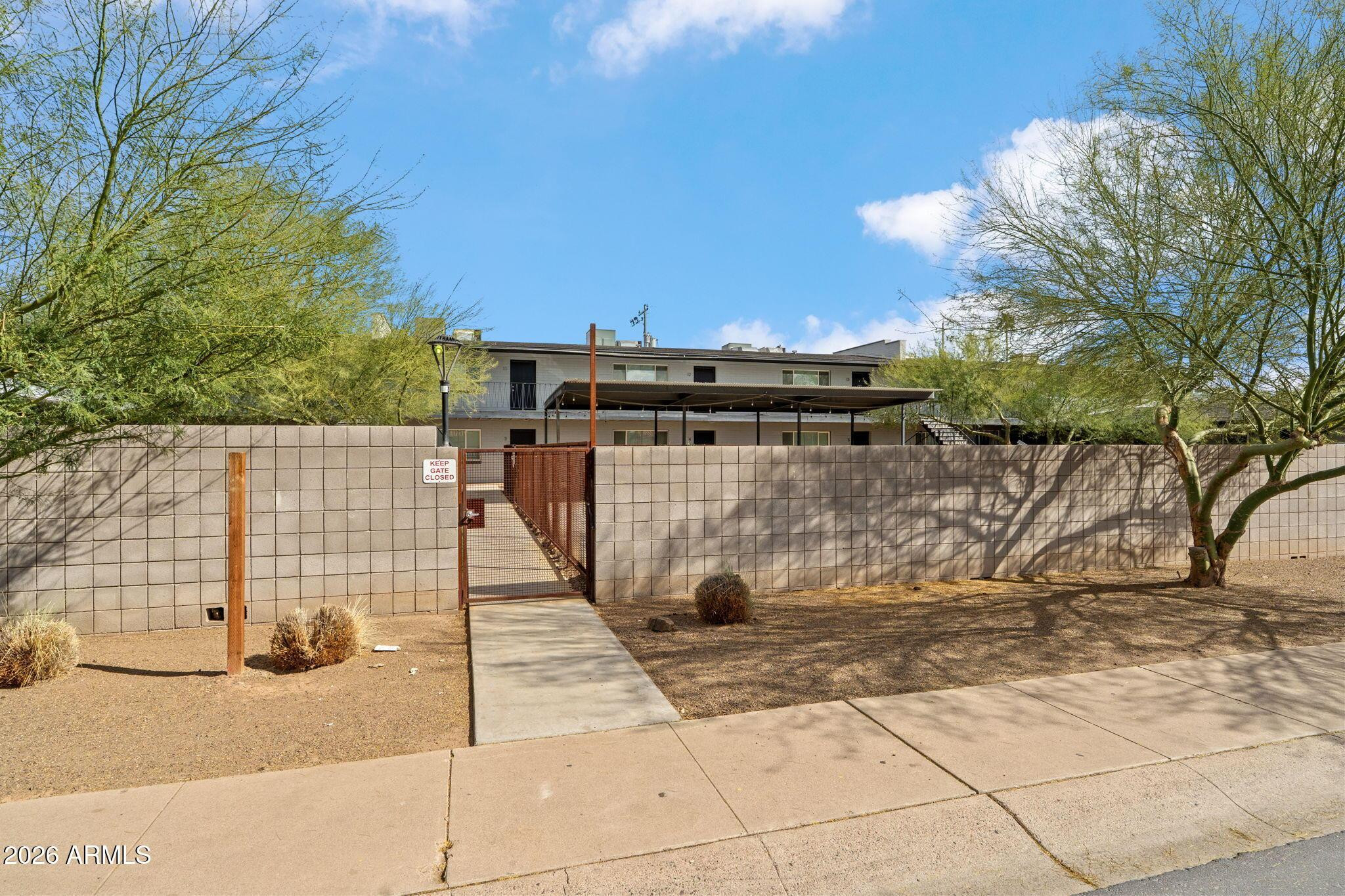 1707 North 18th Street, Unit B7 Phoenix, AZ 85006 - Photo 4 of 14 a view of a pathway with a wrought fence
