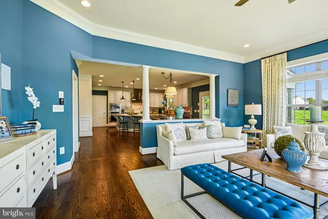 a view of a dining room with furniture a chandelier and a large window