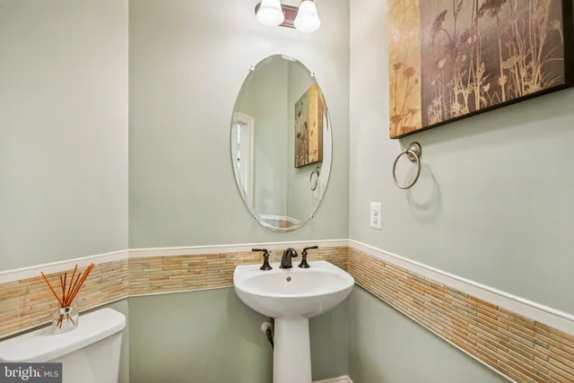 a bathroom with a sink toilet vanity and shower