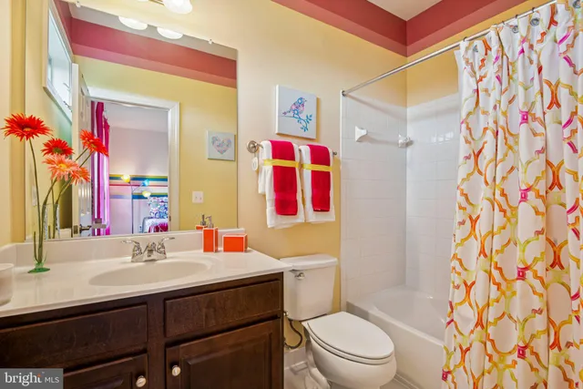 a kitchen with granite countertop a sink and white cabinets