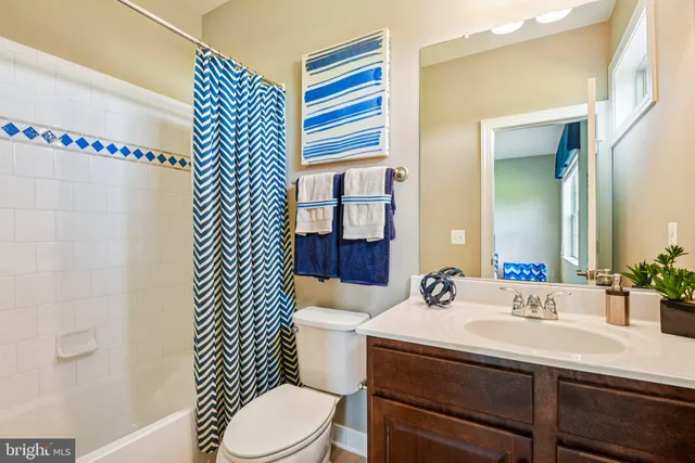 a view of a dining room with furniture and a chandelier