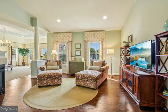 a living room with furniture fireplace and rug