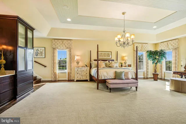a view of a patio with a dining table chairs and a floor to ceiling window