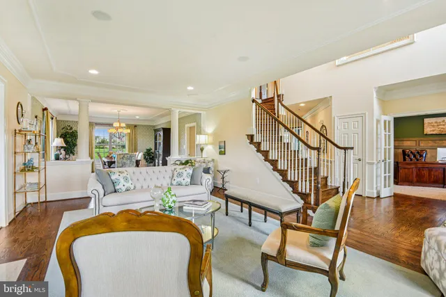 a living room with furniture and floor to ceiling windows