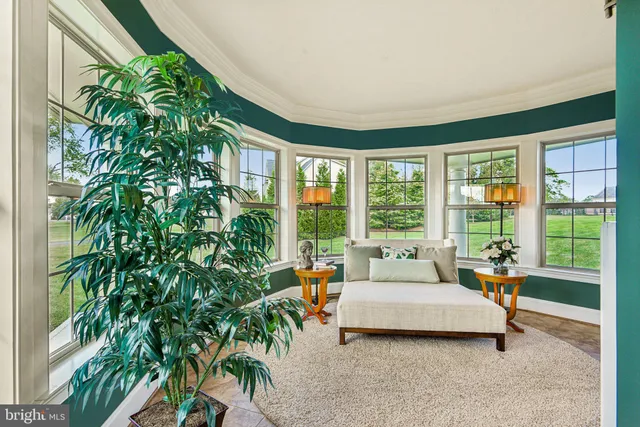 a living room with furniture fireplace and a large window