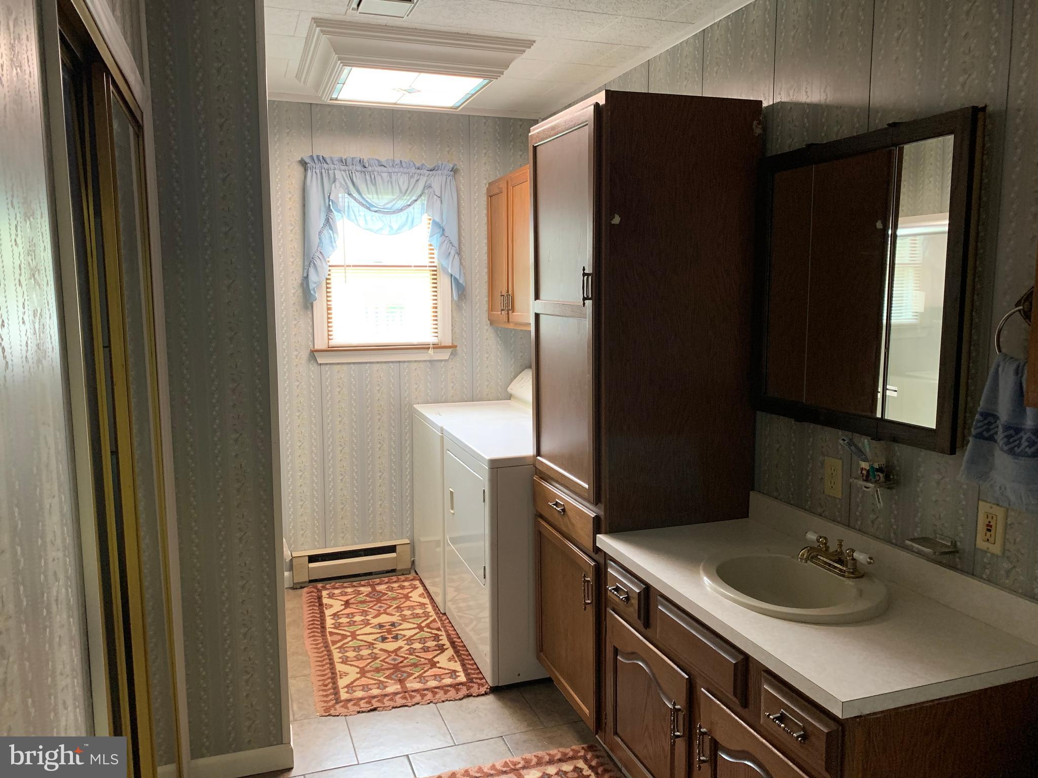 2450 Boteler Road Brownsville, MD 21715 - Photo 15 of 46 Downstairs bathroom with washer and dryer