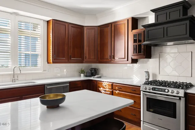 a kitchen with stainless steel appliances a stove a sink and a microwave