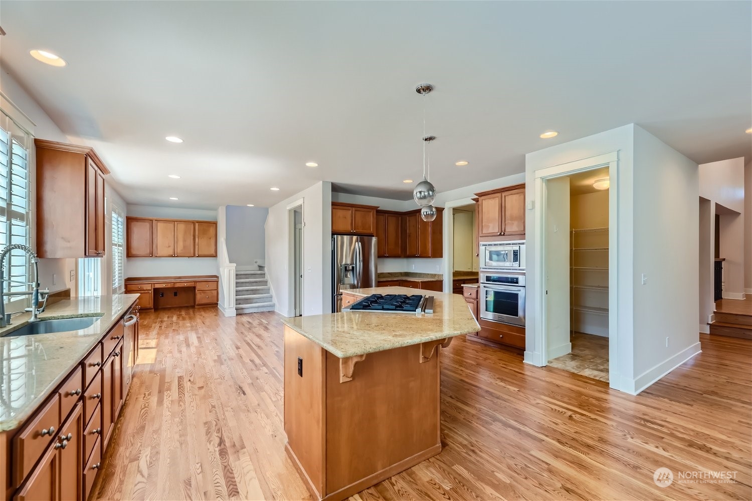 3604 184th Place Southeast Bothell, WA 98012 - Photo 9 of 39 a view of a kitchen with kitchen island stainless steel appliances refrigerator stove microwave and cabinets