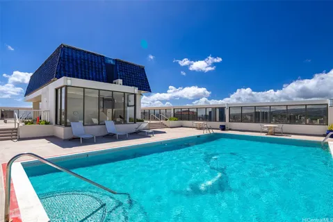 a view of a house with swimming pool and sitting area