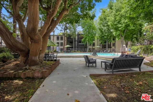 a view of a patio with a table chairs and a backyard