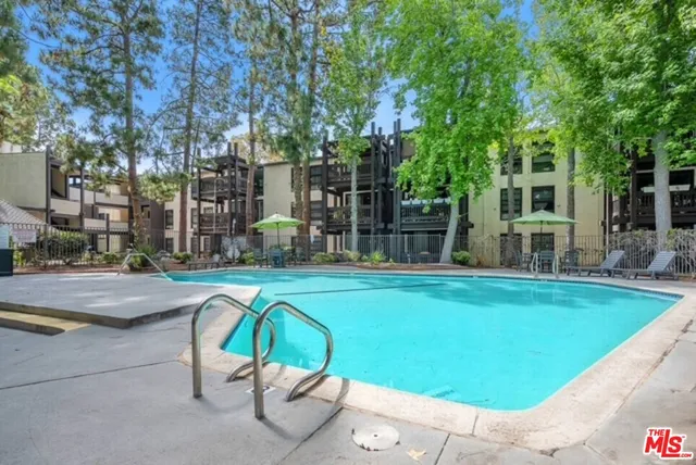 a swimming pool with outdoor seating and yard