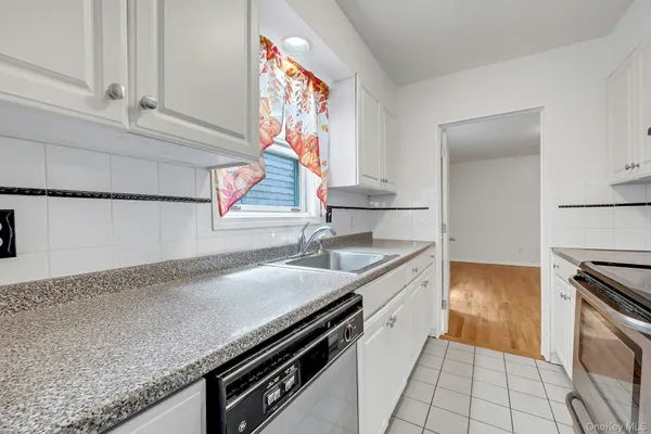 a kitchen with granite countertop a sink and a stove