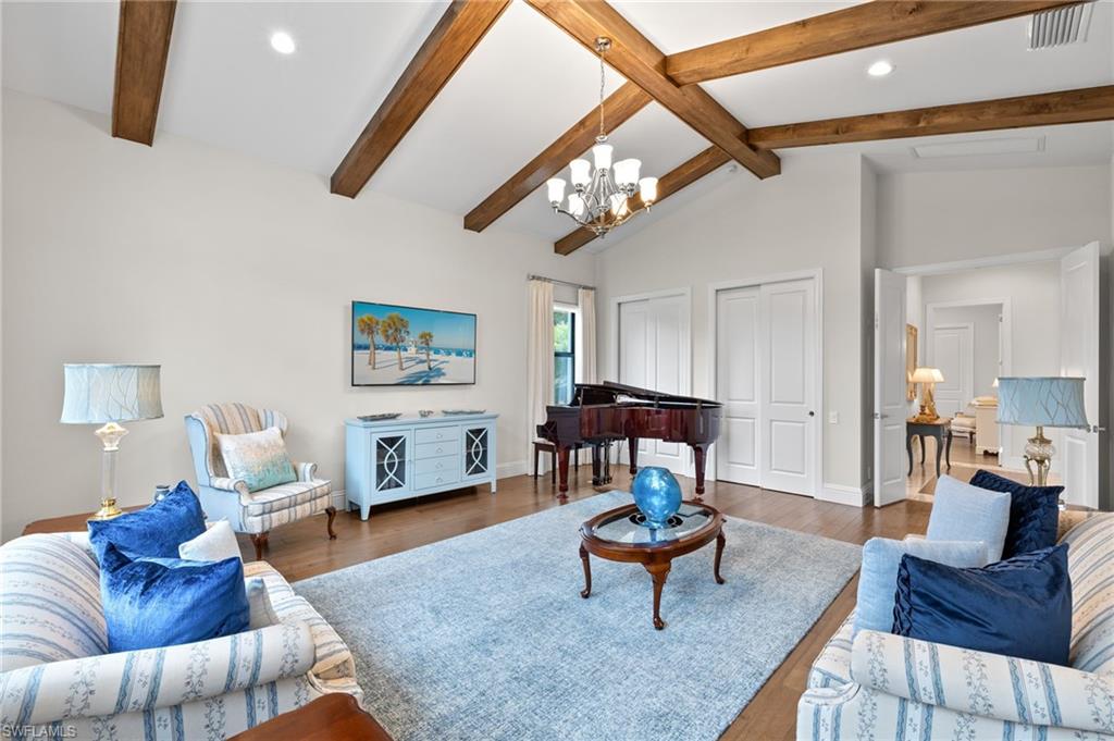 11681 Bald Eagle Way Naples, FL 34120 - Photo 14 of 50 a living room with furniture a flat screen tv and a table
