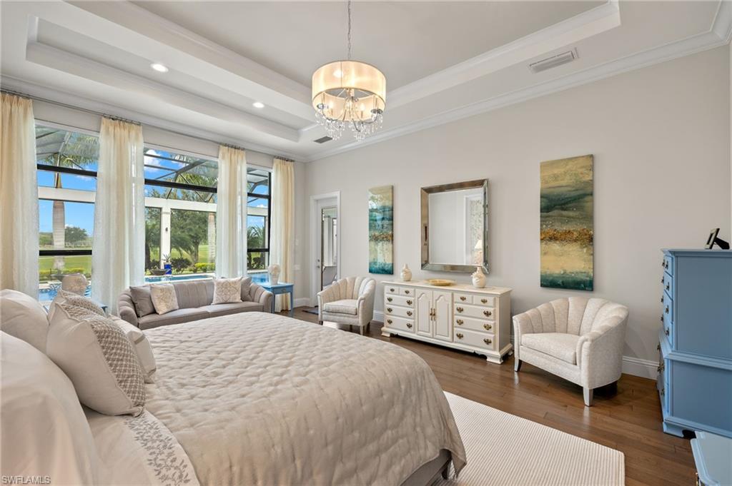 11681 Bald Eagle Way Naples, FL 34120 - Photo 17 of 50 a spacious bedroom with a bed and a large window