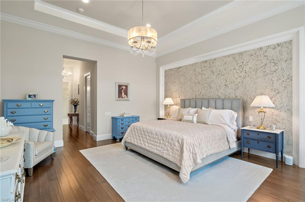 11681 Bald Eagle Way Naples, FL 34120 - Photo 18 of 50 a bedroom with a bed and wooden floor