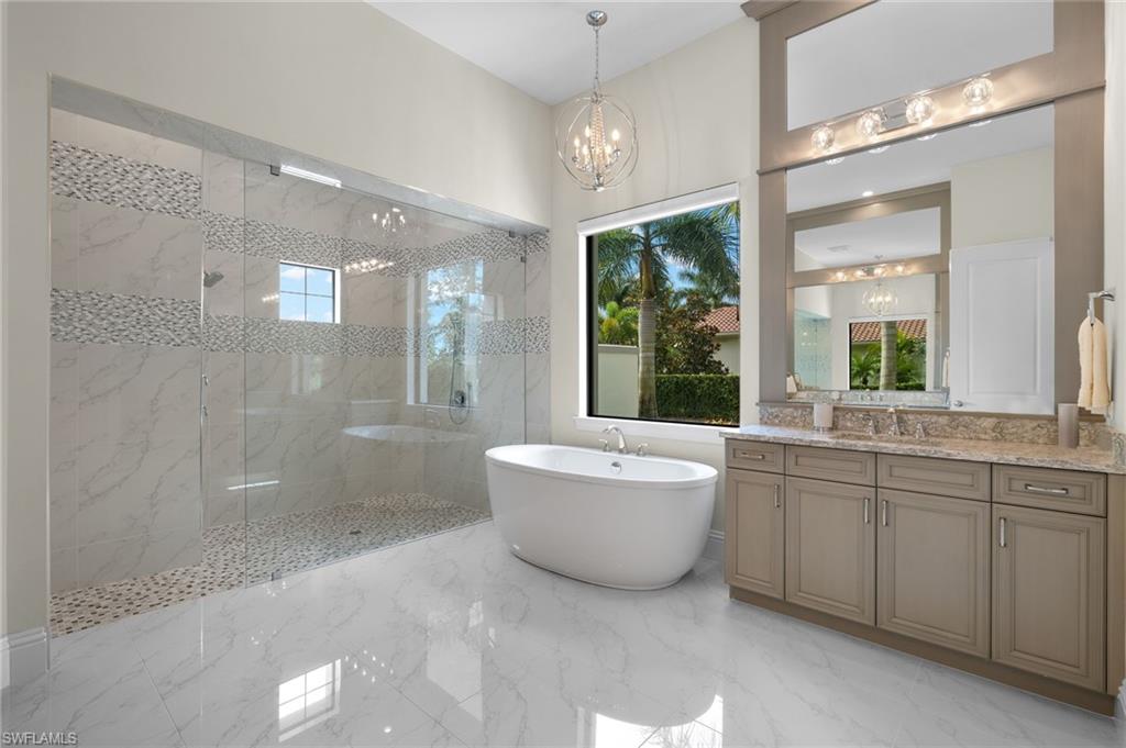 11681 Bald Eagle Way Naples, FL 34120 - Photo 19 of 50 a large spacious bathroom with a large tub shower and sink