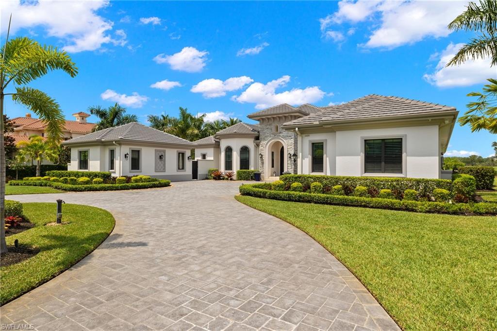 11681 Bald Eagle Way Naples, FL 34120 - Photo 2 of 50 a front view of a house with garden