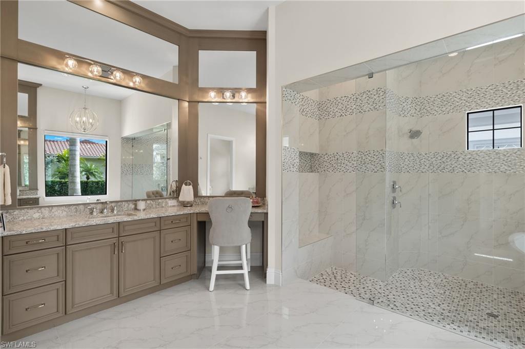 11681 Bald Eagle Way Naples, FL 34120 - Photo 21 of 50 a bathroom with a double vanity sink a toilet and a shower