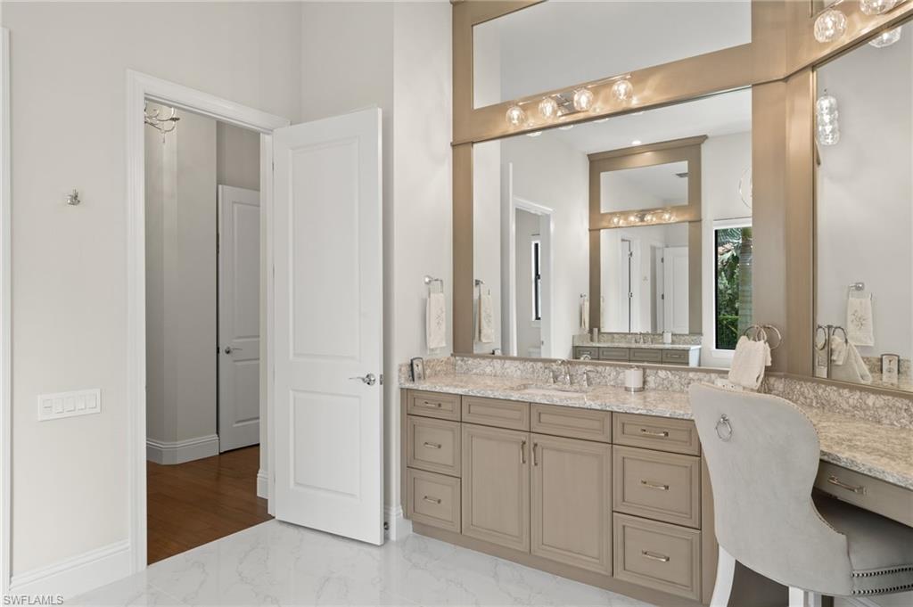 11681 Bald Eagle Way Naples, FL 34120 - Photo 22 of 50 a bathroom with a granite countertop sink and a mirror